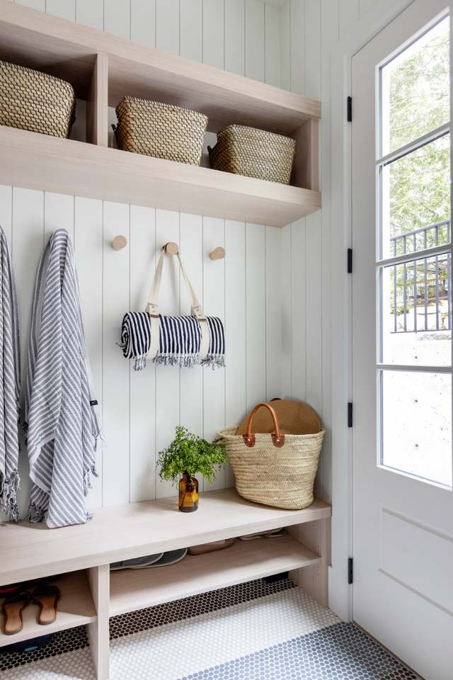 lake house entryway with blue and white penny tile flooring, wooden bench and shiplap walls